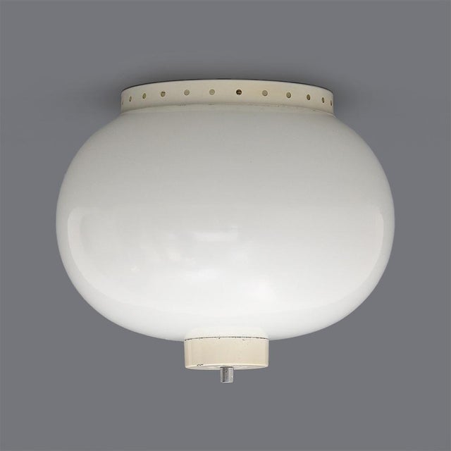 Italian-made ceiling light produced in the 1960s. White painted metal structure. White glass diffuser. Chromed metal...