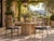 Stylish set of four vintage 1970s outdoor garden dining chairs featuring slender black-painted metal frames with tall open...