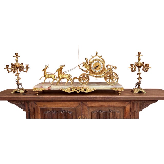 An elegant carriage clock set with complementary candlesticks, known as a "garniture," is characteristic of the Napoleon...