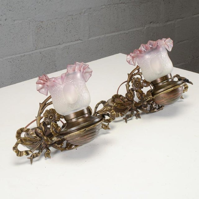This pair of vintage wall sconces, dating back to the first half of the 20th century, perfectly expresses the Art Nouveau...