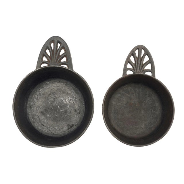 Graduated nest of two English cast iron One Pint & Two Pint porringers with pierced anthemion handles. Made for the...