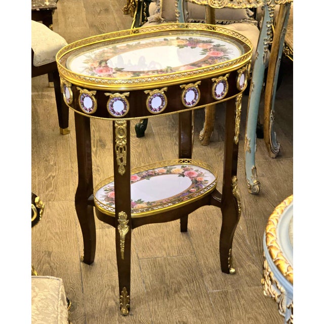 Transform your home with the elegance it deserves. This beautiful Rococo-style coffee table features a rich copper-toned...