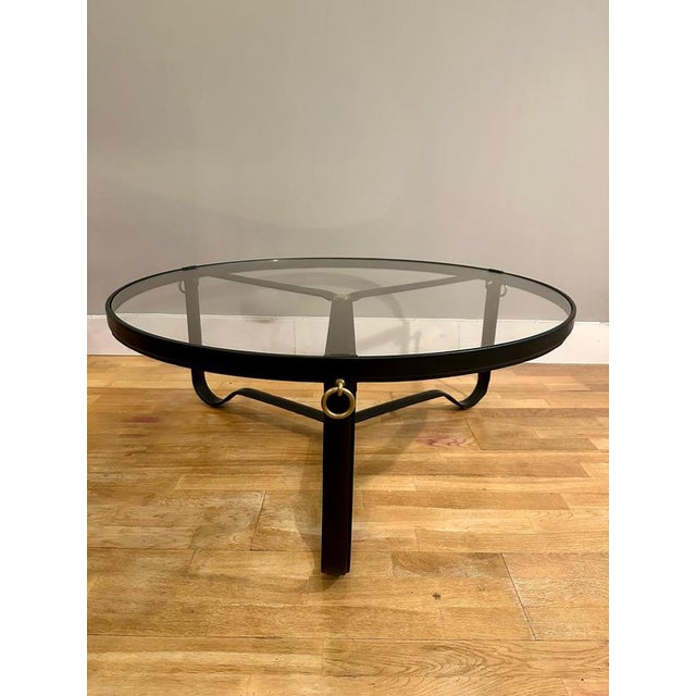 Manufactured by Gubi Denmark This Black leather Jacques Adnet Circulaire Coffee table in stitched black leather, brass...
