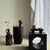 Black ceramic bud vase with a terracotta handle, Indonesian style. Height: 17cm; Maximum diameter: 13cm; Weight: 0.63kg....