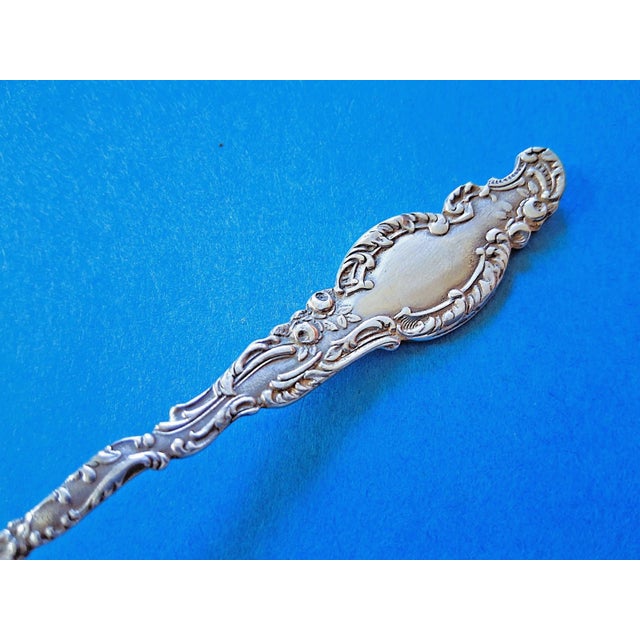 This is a rare 1891 Durgin Watteau sterling silver pierced long handled olive spoon. Stamped on the back with the 'D'...