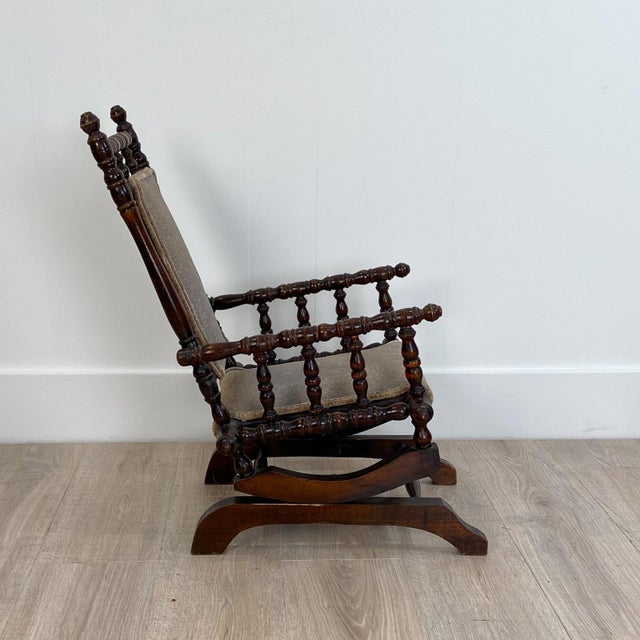 An American beechwood child's platform rocking chair, circa 1880.