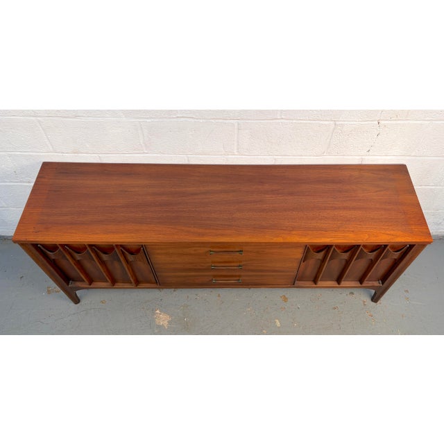 A classic mid-century modern low sideboard crafted from richly grained walnut. Features clean, streamlined lines and...