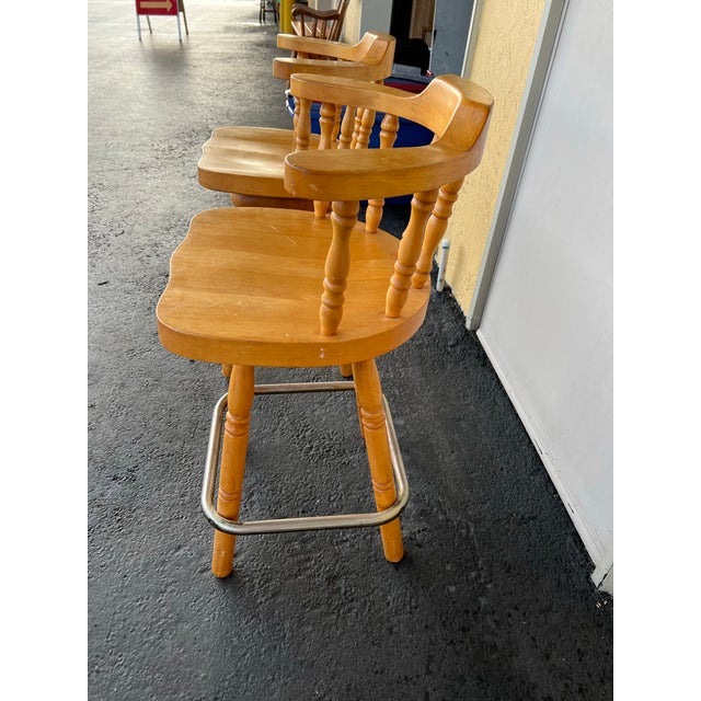 These vintage wood bar stools feature swivel mechanism and a classic captain's chair design. Crafted from solid wood with...