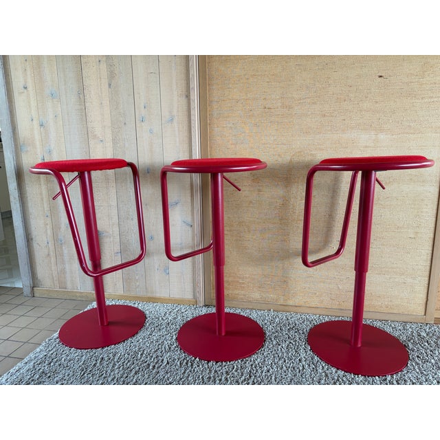 A striking design where a single bent steel tube forms the entire structure — cradling the seat and doubling as an...