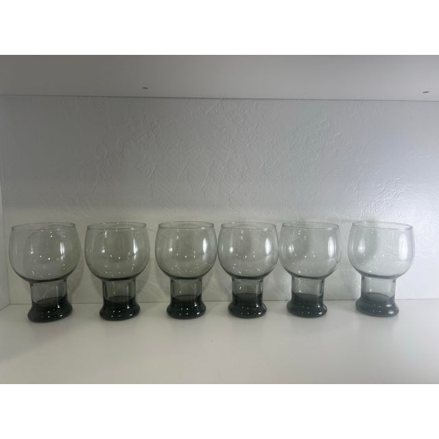 The image shows a set of 6 vintage Federal Glass Sundown Smoke Gray Pedestal Beer Glasses made in the mid 1960’s. These...