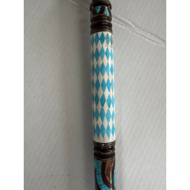 A stunning vintage cane/walking stick ornately decorated with inlaid turquoise and agate.