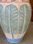This vintage coastal floor vase, monumental in scale, is sculpted from cast plaster in the shapes of an elegant palm leaf...