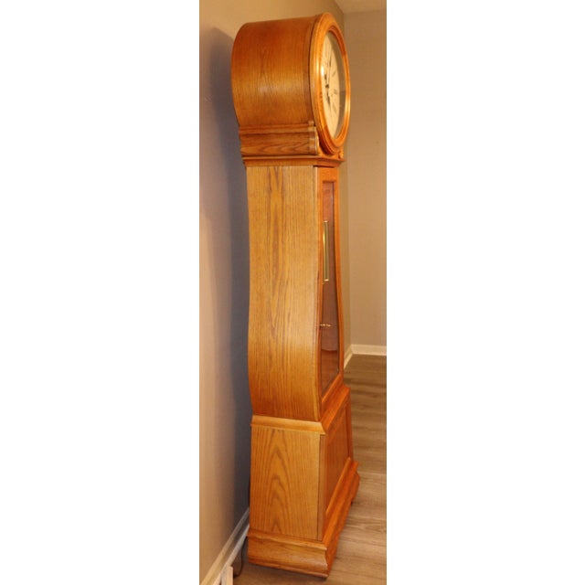 A well-proportioned Howard Miller Curved Front Grandfather Clock (Model 610-934), combining classic longcase form with a...