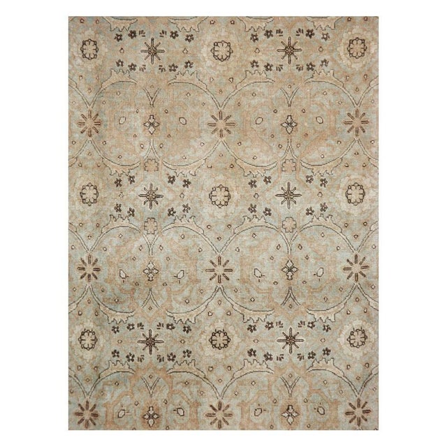 This early 20th-century Persian Tabriz small room-size carpet presents a refined allover floral composition across a pale...
