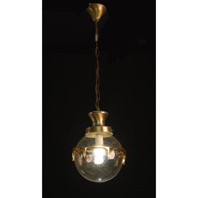 Pretty ceiling lamp of spherical shape with special bubble glass. Surrounding the light glass is a circular glass strip. A...
