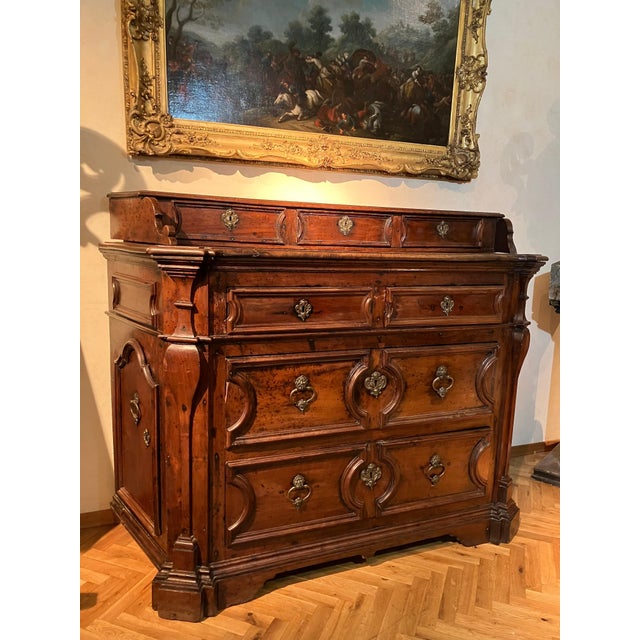 This magnificent italian 17th-century solid walnut chest of drawers (canterano), is a testament to the craftsmanship of...