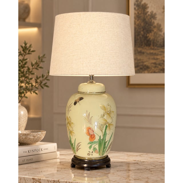 Ceramic table lamp in a ginger-jar shape, decorated with floral, botanical and butterfly motifs on a soft cream ground....
