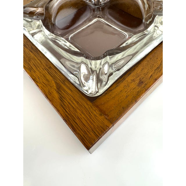 A refined mid-century catchall by Rothschild, featuring a sculptural clear glass insert set within a solid American walnut...