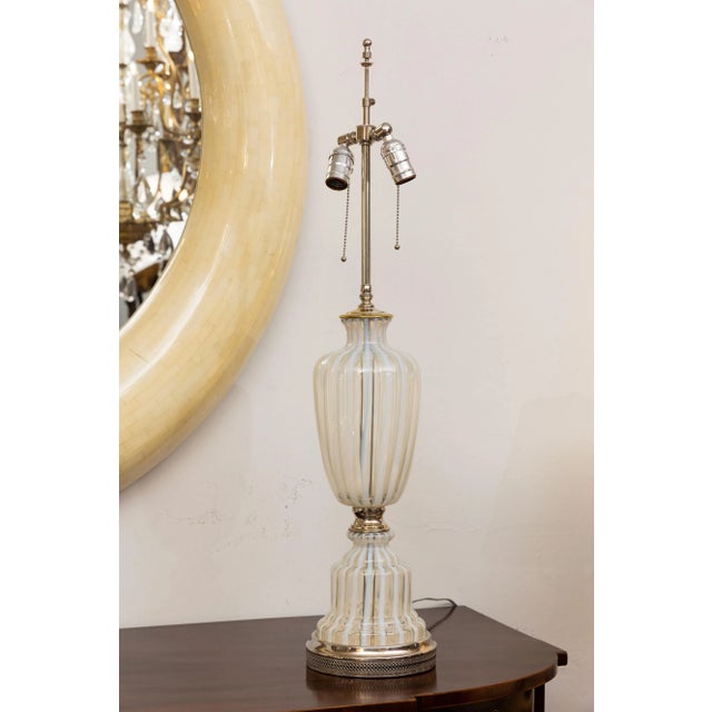 This is a lovely pair of Italian Murano urn-form glass lamps comprised of repetitive alternating stripes of white and...