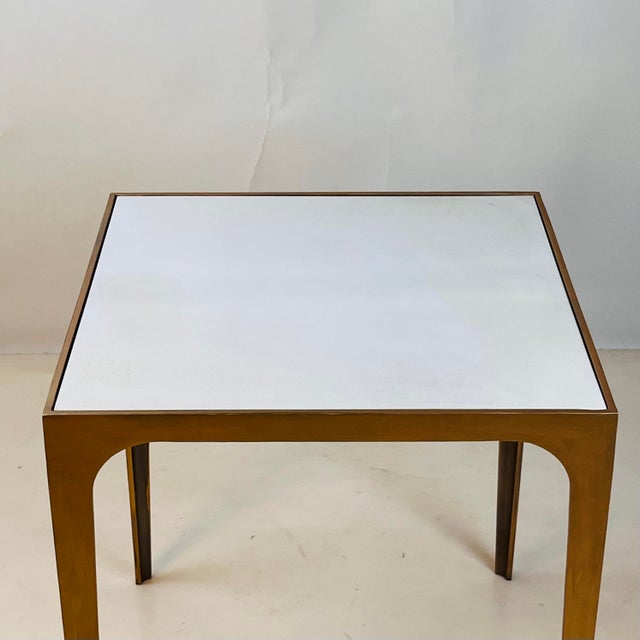 This compact side table pairs a hand-finished gilt metal frame with a luxurious goatskin-clad top, creating a refined...