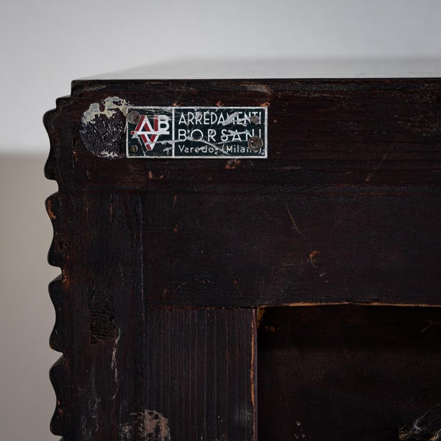 Two-door sideboard in dark-stained wood with a fluted front and carved decorative legs. The interior is fitted with six...