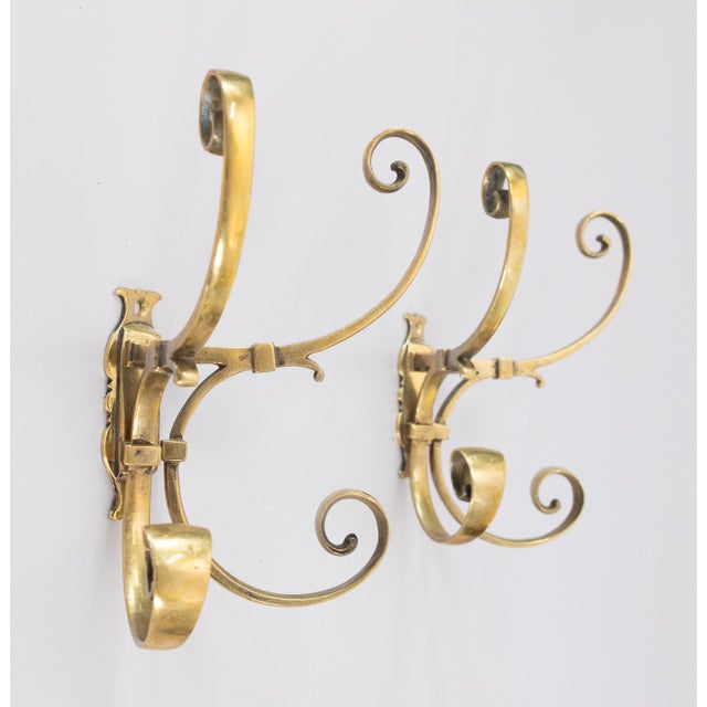 A gorgeous pair of antique French brass coat and hat racks wall hooks, circa 1920. These stylish coat racks each have four...