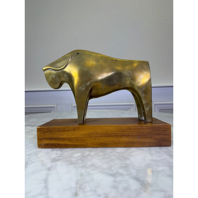 Capture the powerful essence of Mid-Century Modern design with this exceptional vintage solid brass abstract bull...