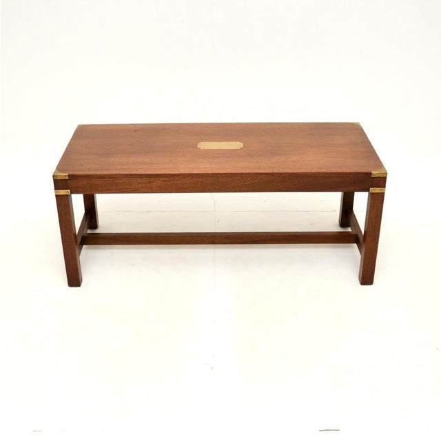 A superb antique military campaign style coffee table. This was made in England, it dates from around the 1930’s. The...