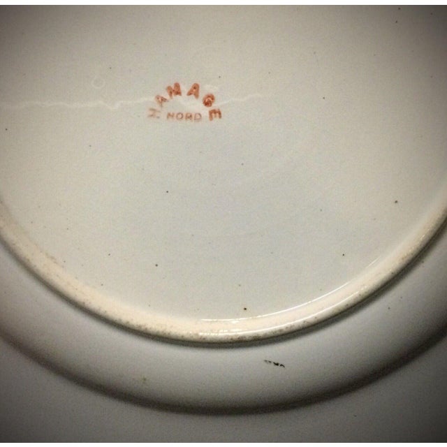 Discover the charm of vintage ceramics with this antique faience plate from "Hamage Nord," dating from the 20th century or...