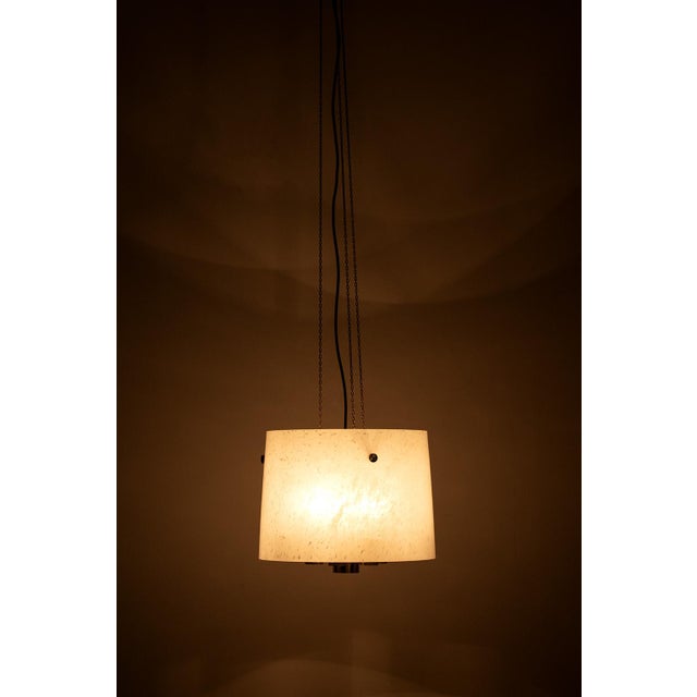 Glashütte Limburg hanging lamp made from glass and brass. The glass shade creates a beautiful light. In a good vintage...