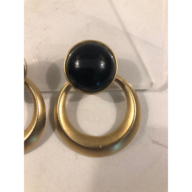 This fabulous pair of 1970s Trifari Black Enamel & Gold Door Knocker Earrings will be the eye-catching accessory your...