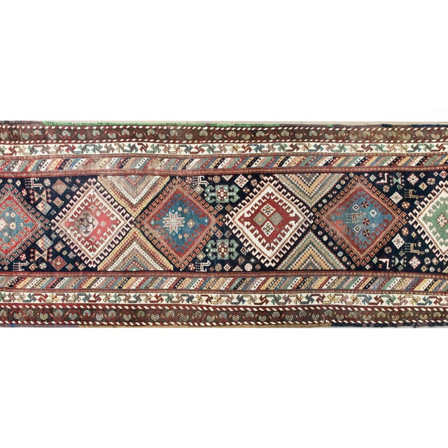 A beautiful early 20th-century Persian Qashqai runner, handwoven with six large diamond medallions, each filled with...