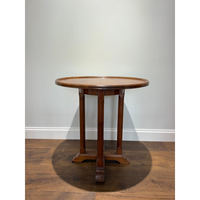 An intriguing and highly decorative antique burl veneer lamp table dating to the late Victorian or Edwardian period, circa...