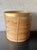 A large vintage pencil reed planter featuring tightly wrapped natural rattan construction accented by a polished brass...