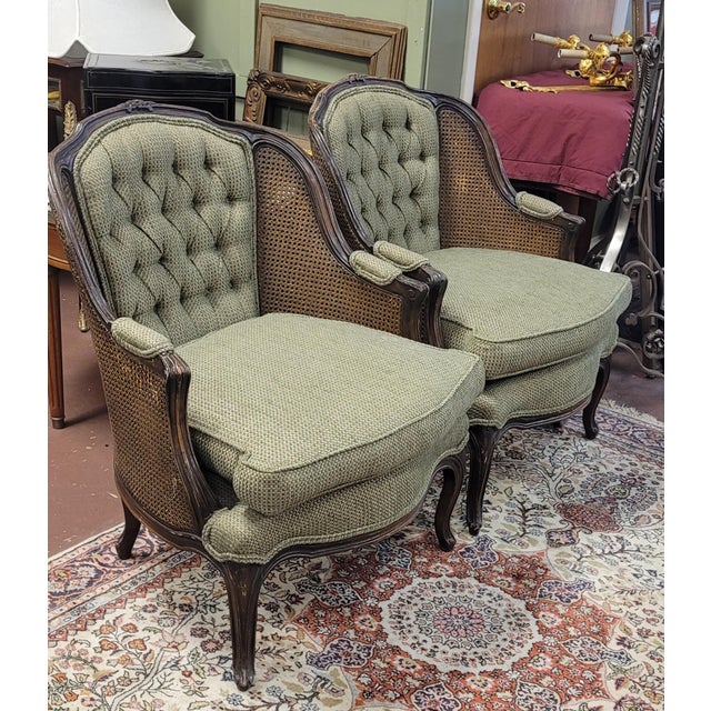 A fine pair of French Bergere double cane armchairs. Each features carved French Louie the 15th frames double cane side...