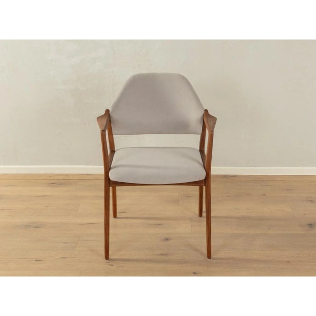 A classic armchair from the 1960s by Wilkhahn, model "440b," with a walnut frame. The chair has been reupholstered and...