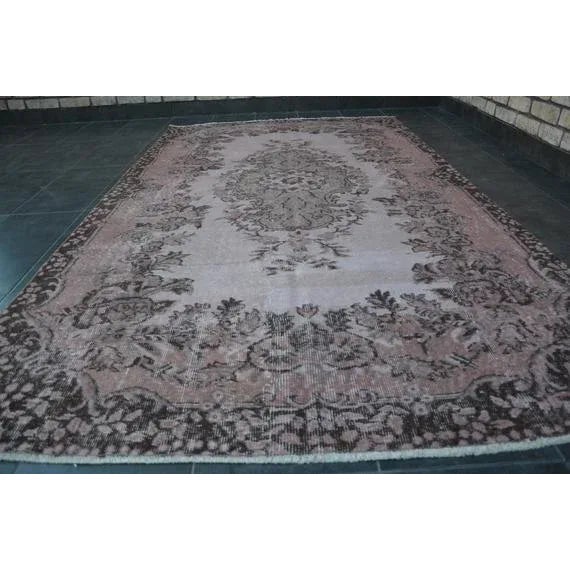 This is a vintage Turkish Oushak rug from the 1960s. The piece was hand-knotted.