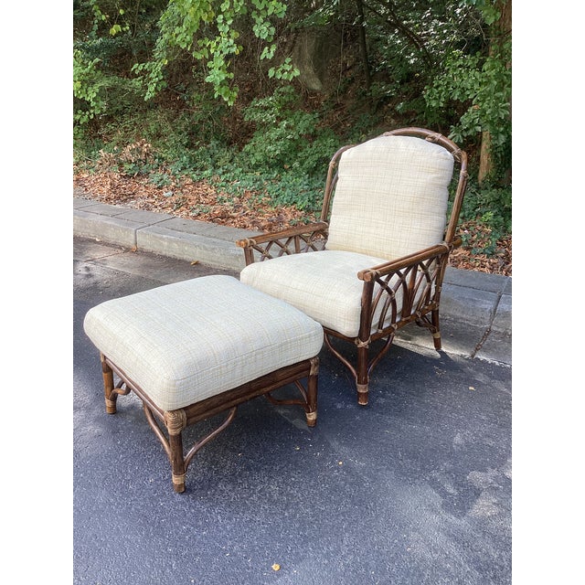 A handsome vintage McGuire lounge chair and matching ottoman, newly upholstered in a softly textured, pale yellow and...