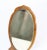 Small table mirror in walnut wood with small metal foot from around the 1880s. Dimensions in cm: H:30 W:15.5.