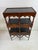This is a handsome walnut and brass etagere by Theodore Alexander. This etagere features a beautifully finished dark...