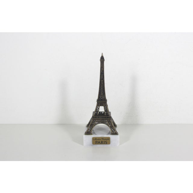 Small gold Eiffel tower souvenir of Paris, France. I believe the metal is brass, but not positive. The base is real...