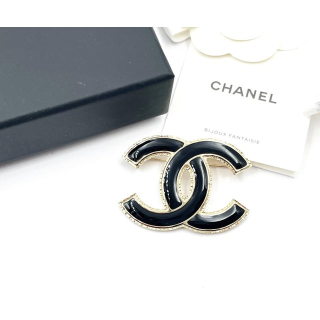 This is part of Chairish's Costume Jewelry assortment. Chanel Brand New Classic Gold CC Frame Black Brooch *Marked 22...