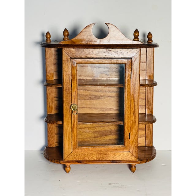 Antique oak multitier display case with glass door.