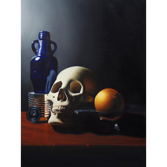 This oil on panel artwork presents a contemporary vanitas scene, featuring a detailed skull, a vibrant orange, and a...