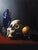 This oil on panel artwork presents a contemporary vanitas scene, featuring a detailed skull, a vibrant orange, and a...