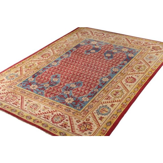 Emerging from the golden era of Anatolian weaving, this 9x13 antique Oushak stands as a masterful testament to early 20th-...