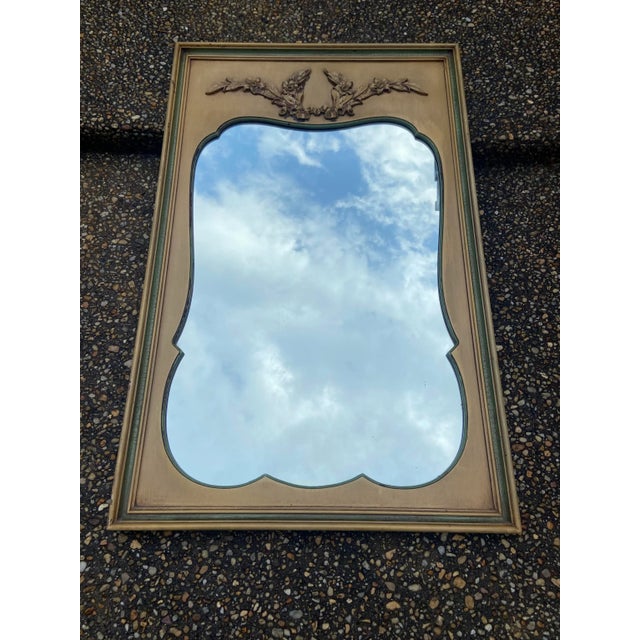 Lovely vintage French country rectangular-shaped trumeau mirror with embossed or applied floral sway at the pediment and...