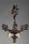 Pair of large candelabra crafted in patinated bronze, accentuated with gilt bronze accents. Each antique candleholder is...