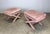 A classic pair of Billy Baldwin style upholstered X-base benches in faded dusty pink striped velvet velour fabric. One...