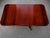 An elegant vintage Regency-style double pedestal dining table showcasing an extraordinary flame mahogany veneer top with...